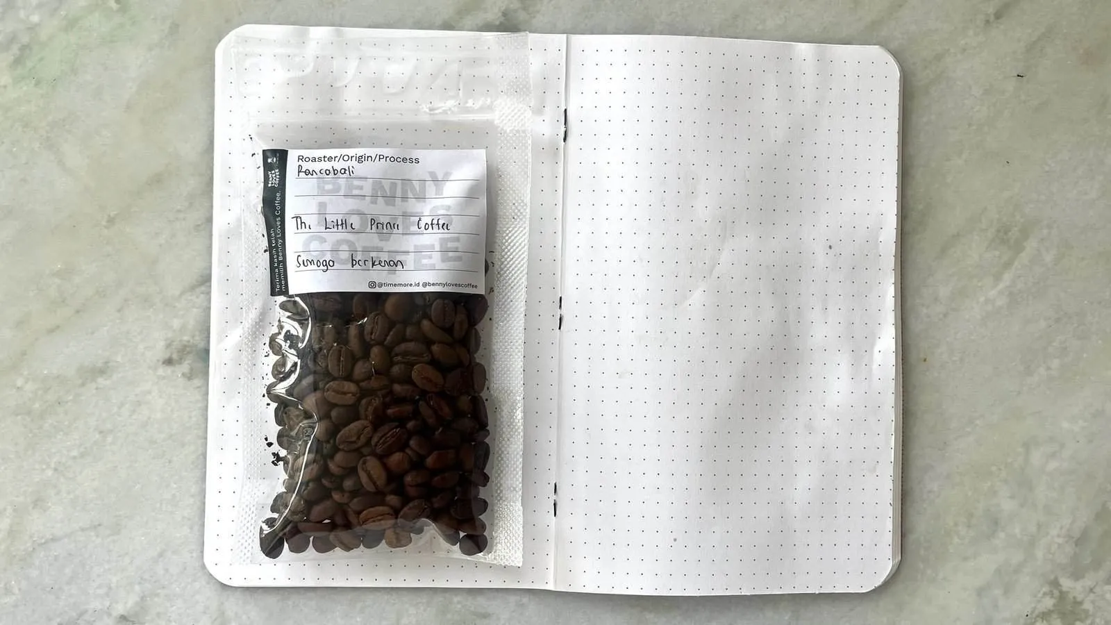 Fresh coffee beans in a clear bag with handwritten label 'The Little Paper Coffee' for specialty coffee, perfect for brewing lovers and roasting enthusiasts seeking high-quality beans.